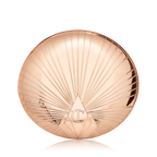 A closed, pressed powder compact in golden, metallic packaging with a starburst pattern on the lid. 